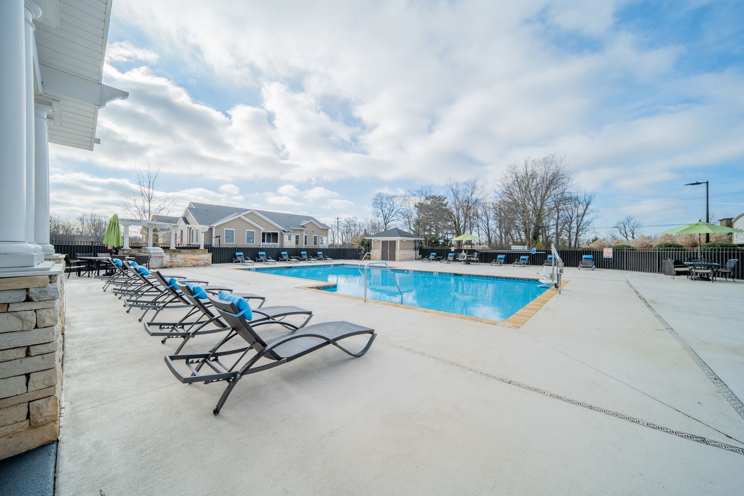 Sparkling swimming pool and spacious sundeck at Piedmont Place apartments in Greensboro, NC